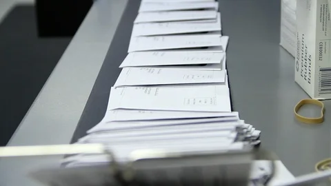 Mail moving down a conveyor to be sorted Stock Footage 106002707