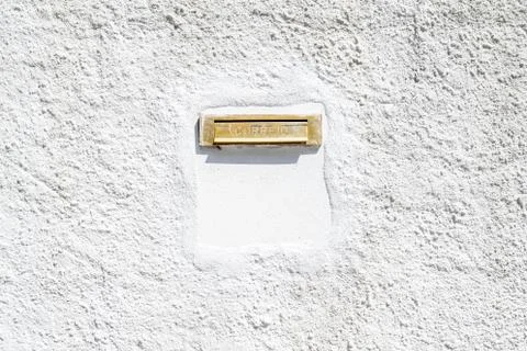 Mail stuck in the old wall painted white. Stock Photos