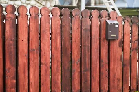A mailbox is hanging on a fence Stock Photos
