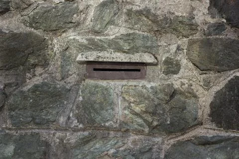 Mailbox opening on a stone wall Stock Photos