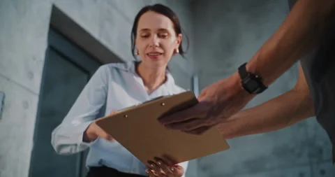 Mailman Bringing Padded Envelope for Recipient to the Office, Getting Clients Stock Footage 312382727
