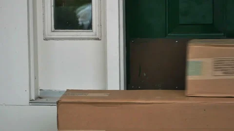 Mailman Delivered Package Boxes Sliding into the Door in Slow Motion Stock Footage 56850445