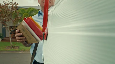 Mailman putting some mail into the mailbox Stock Footage 263972363