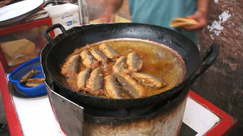 THE MAIN BAZAAR, MARRAKECH - AUGUST 1, 2013: Man fried fish at market on August Stock Footage 39513091