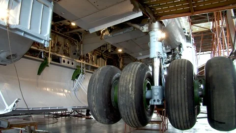 Main chassis IL-76 aircraft with wheels moves up and becomes  on lock. Stock Footage 108802382