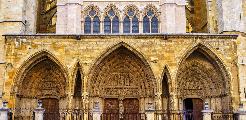 Main facade of the Gothic Cathedral of Leon with highly decorated old doors. Stock Photos