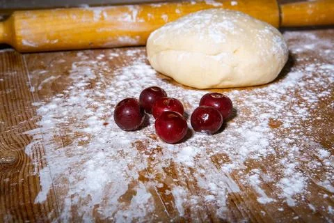 Main focus on pastry chef hand sculpting cherry dumplings. Process of cooking Stock Photos