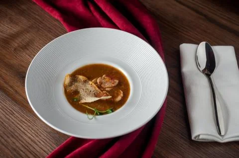 The main meat dish on a large deep plate. Restaurant Stock Photos