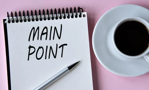 MAIN POINT - words written in a notebook on the background of a cup of coffee Stock Photos