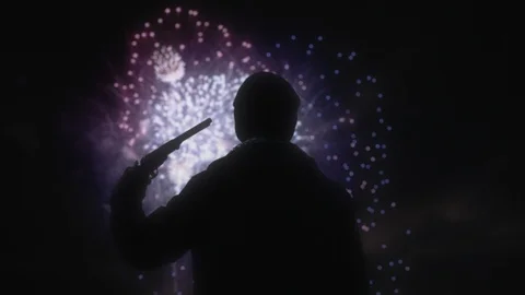 Main Pointing Gun at Head in Front of Sky Full of Beautiful Fireworks Stock Footage 86688013