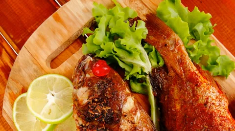 Main portion of two grilled fish served on wood Vídeos de archivo 38726457