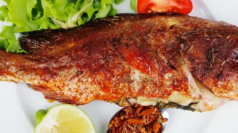 Main portion of two grilled fish served on plate 库存影片 46230287