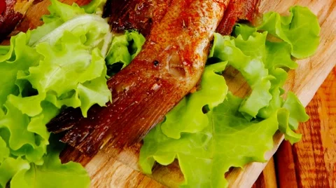 Main portion of two grilled fish served on wood Vídeos de archivo 63995215