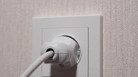 Main pulls out the electrical plug in socket wire Stock Footage 124723238