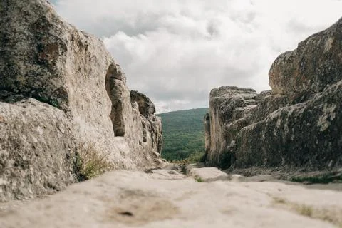 Main road between caves in ancient town Eski-Kermen. Stock Photos
