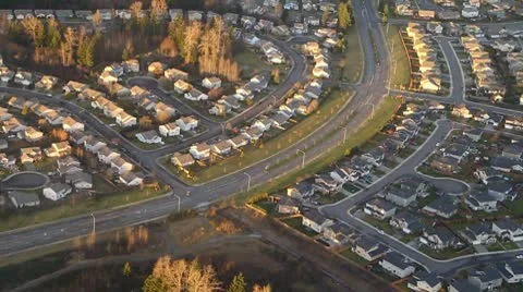 Main Road Running Through Large Suburban Neighborhood - Aerial Stock Footage 10577686
