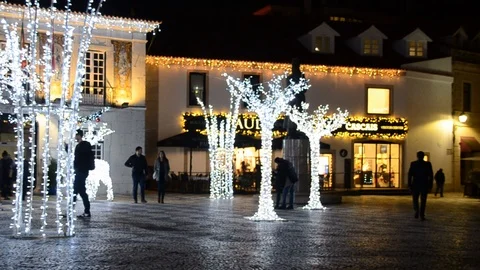 Main Square of Cascais covered in bright illuminated Christmas lights and Stock Footage 99146023