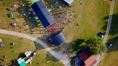Main stage of outdoor music festival. Ascending, rotating aerial Stock Footage