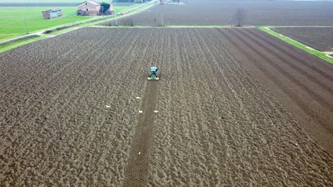 Main tillage tractor with an implement with rotating parts that break the soils Stock Footage 167293222
