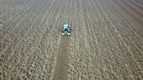 Main tillage tractor with an implement with rotating parts that break the soils Stock Footage 167293665
