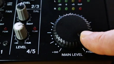 Main volume adjusting on analogue audio mixer. Close up 4k Stock Footage 123833555