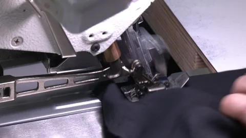 The main working segment of the overlock is a foot with two needles Stock Footage 321828957