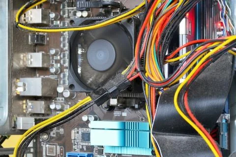 Mainboard and cables inside of the personal computer case covered with dust Stock Photos