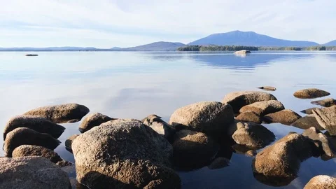 Maine granite rocks, clear water, and Mt Katahdin Stock Footage