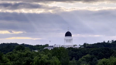Maine State House capitol dome in Augusta at golden hour with dramatic sun rays Stock Footage 341003473