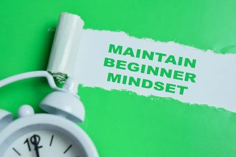 Maintain beginner mindset text written in torn paper. Stock Photos