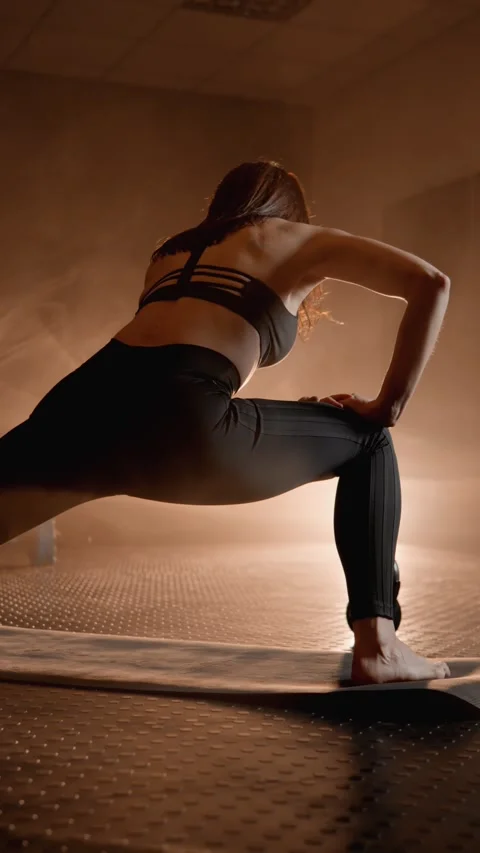 Maintaining body flexibility through stretching. Female athlete focuses on Stock Footage 272634709