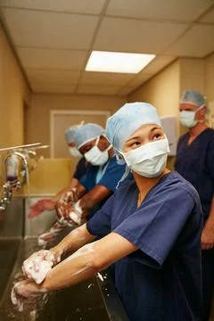 Maintaining cleanliness and hygiene between each operation. a team of surgeons Stock Photos