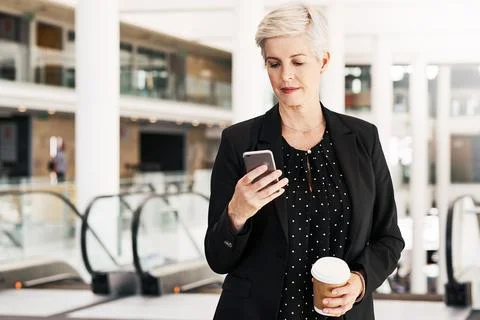 Maintaining her workload with mobile apps Foto stock