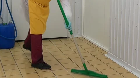 Maintaining Hygiene Worker Uses Squeegee on Floor in Sterile Kitchen Stock Footage 321011697
