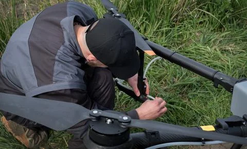Maintenance of an agrodrone by a serviceman Fotos Stock