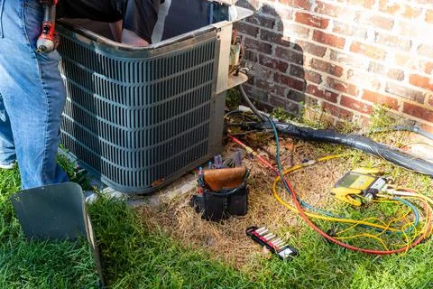 Maintenance on air conditioner unit Stock Photos