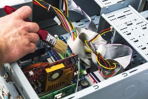 Maintenance and cleaning of the system unit of a personal computer. Stock Photos