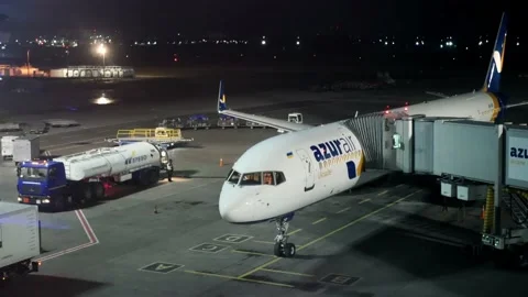 Maintenance and refueling of a passenger plane near the terminal  Stock Footage 154273600