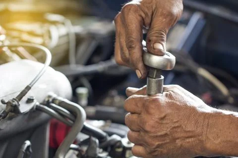 Maintenance car using screwdriver tools. dirty hands fixing repair car engine. Stock Photos