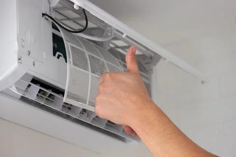 Maintenance Complete. Technician Installing Clean Air Filter in Air Condition Stock Photos