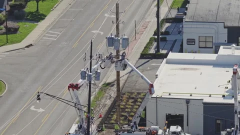 Maintenance construction crew repairing power grid bringing electricity online Stock Footage 343659269