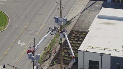 Maintenance construction crew repairing power grid bringing electricity online Stock Footage 343659312