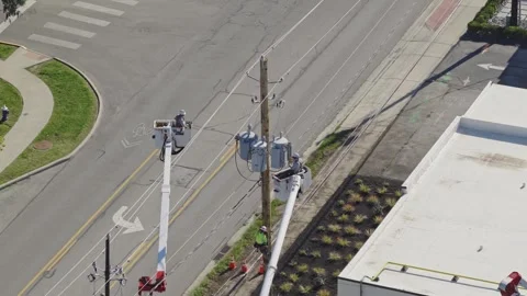 Maintenance construction crew repairing power grid bringing electricity online Stock Footage 343659346