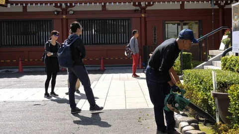 A maintenance crew cutting some grasses in Senso-ji Temple in Tokyo Japan Stock Footage 121382874