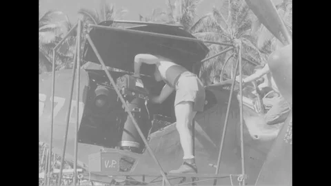Maintenance crew removes camera from P-38 and check camera in camera tent- 1944 Stock Footage 99786358