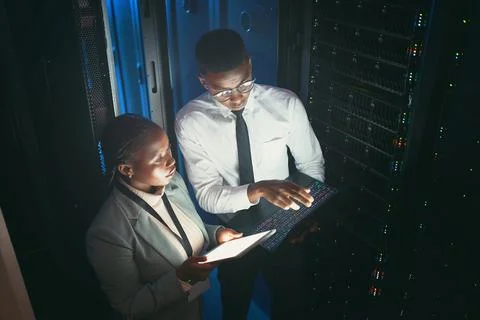 Maintenance, dark or team in server room with tech, above or system inspection Stock Photos