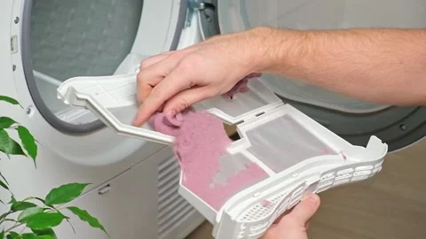 Maintenance dryer after drying cycle. Drying machine Man takes out dirty filter Stock Footage 220523105