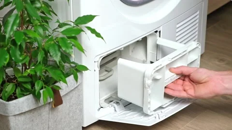 Maintenance dryer after drying cycle. Drying machine Man takes out dirty filter Stock Footage 221583165