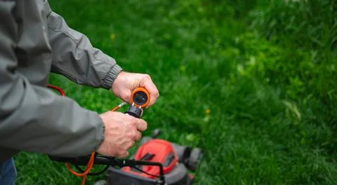 Maintenance of an electric lawn mower highlights the importance of garden care Stock Photos