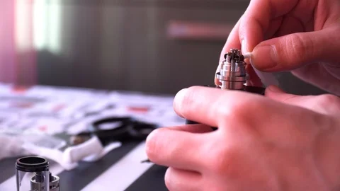 Maintenance of electronic mech mod vaping device.Master repairs vaporizer.Specia Stock Footage 85993493